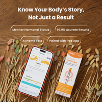 At-home fertility test kit with Vivoo App on a wooden surface with dried plants.