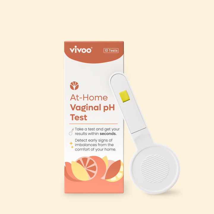At-home vaginal pH test kit with packaging and device on a beige background
