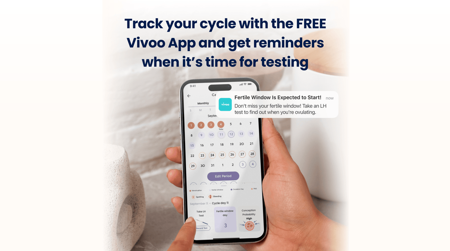 Person holding a smartphone displaying the Vivoo App with text about tracking menstrual cycles.