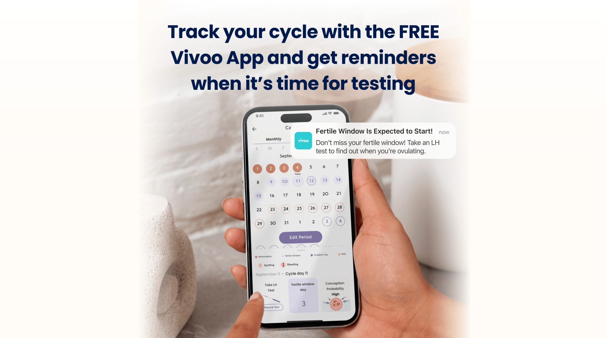 Person holding a smartphone displaying the Vivoo App with text about tracking menstrual cycles.