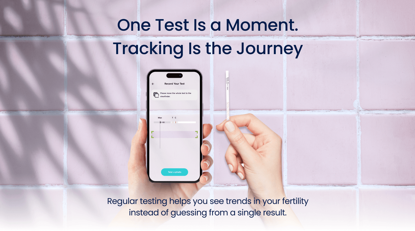 Hand holding a smartphone and fertility test strip on a tiled wall background