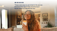 Woman holding Vivoo Fertility Test with text about an app on a blurred background