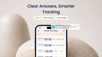 Smartphone displaying fertility test history app with text 'Clear Answers, Smarter Tracking' on a neutral background.