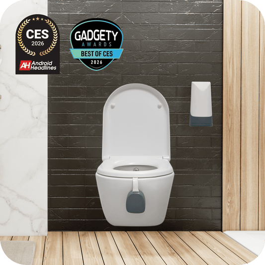 White toilet with additional features against a dark tiled wall, with awards displayed.